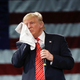 Donald J. Trump wipes his face with a towel at a rally in Tampa, Florida (AP Photo/Gerald Herbert)